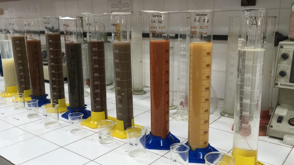 10 graduated cylinders with different soil samples in the lab