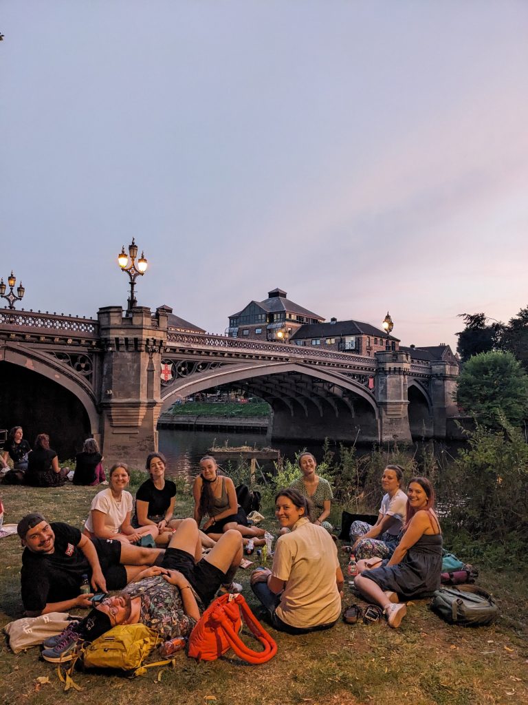 Pictrue of conference participants in a park next to the Skeldergate Bridge by the Ouse River.